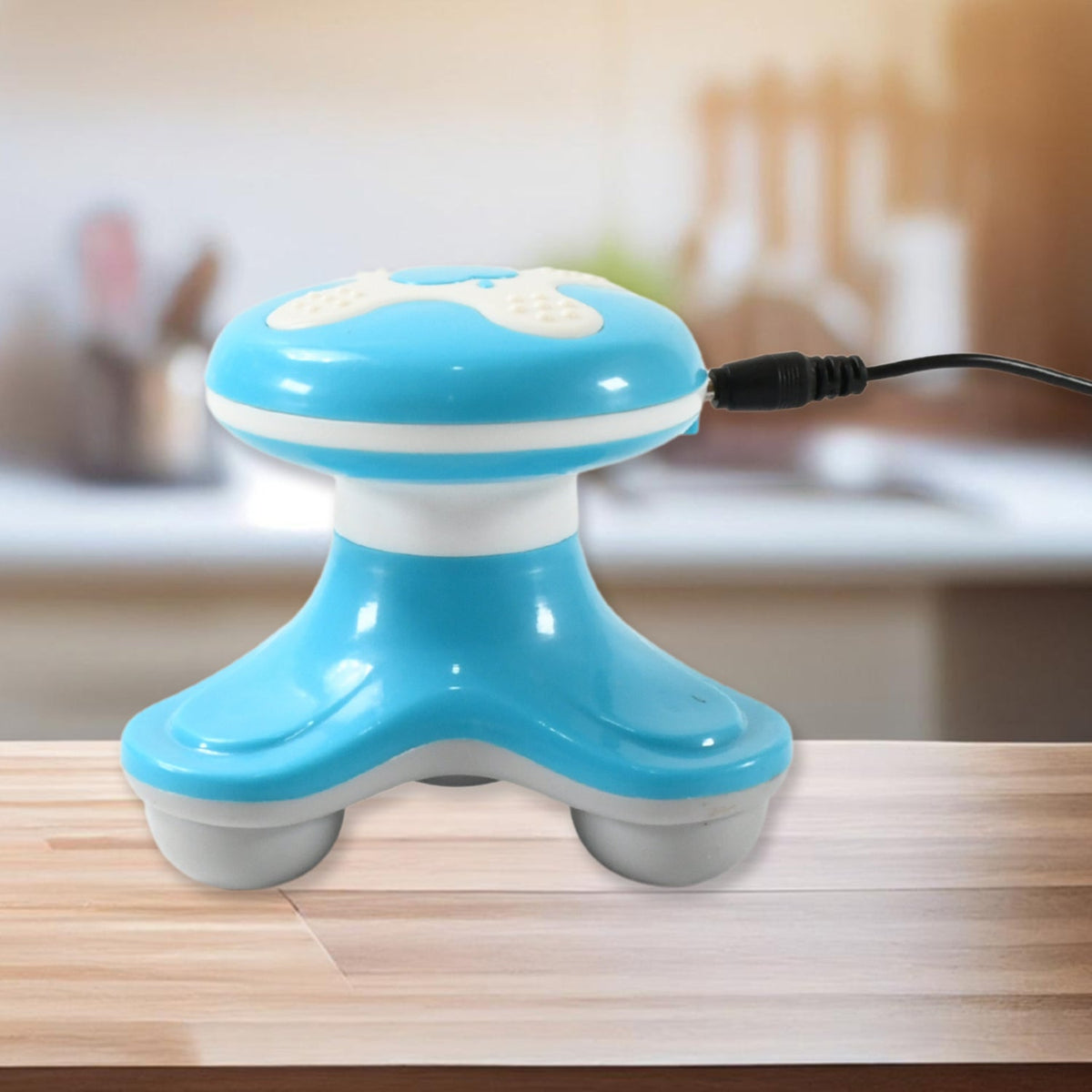 Pocket mini massager shown in the hand for scale