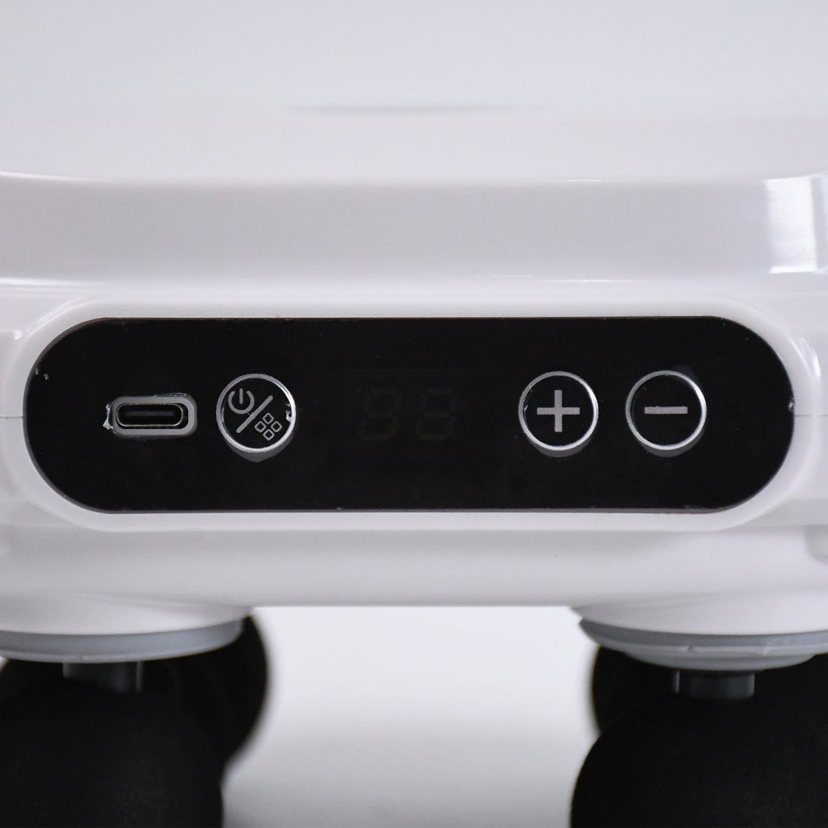 Pulse massage gun in use on the shoulder