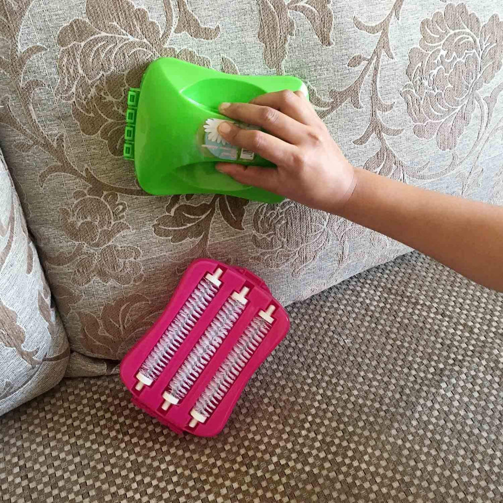 Sweep carpet roller brush in use on a sofa